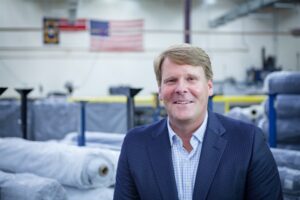 CULP MERGES UPHOLSTERY, MATTRESS TICKING DIVISIONS